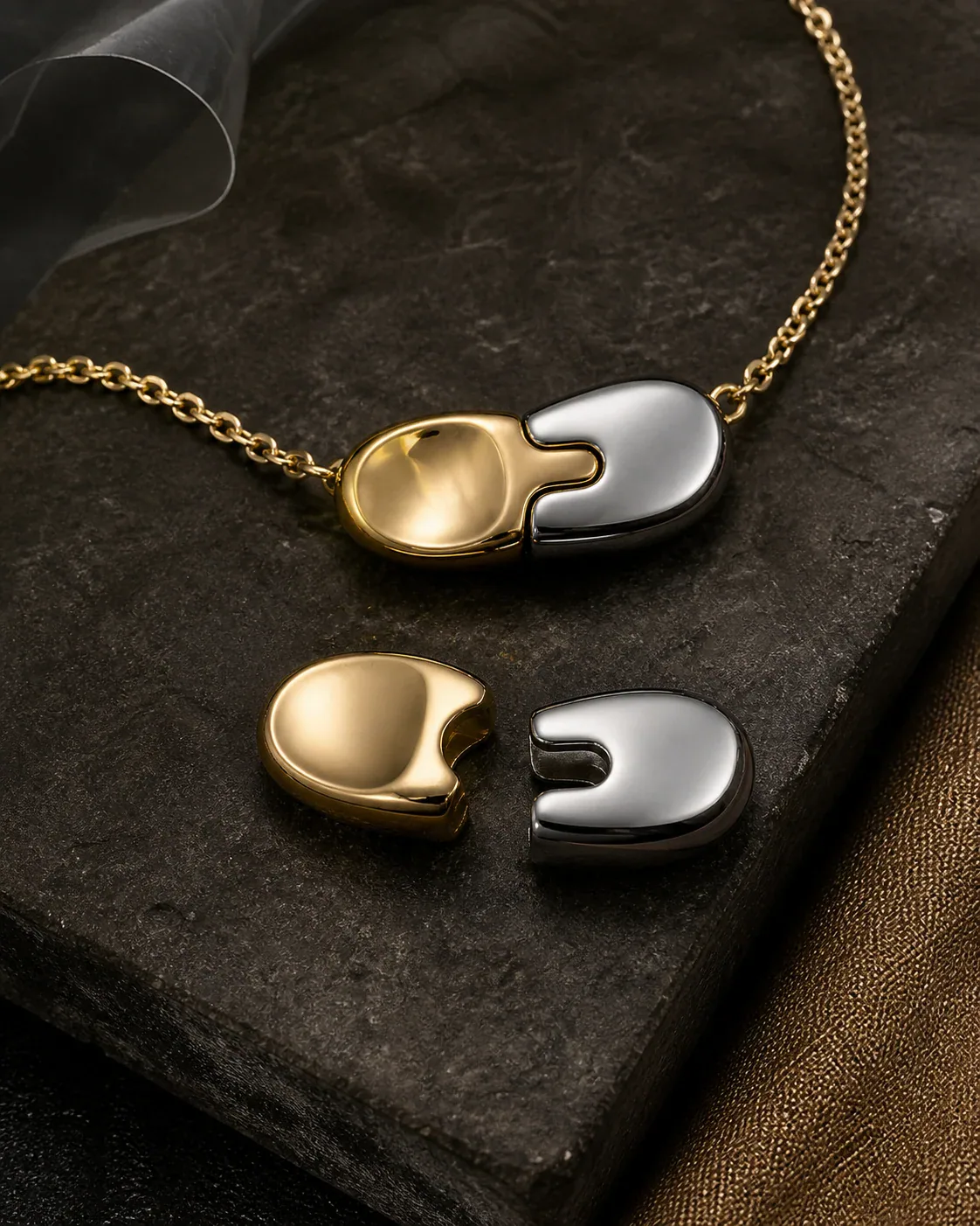 AI-assisted Switchroom design study of a two-part contrasting metal-tone press-and-slide jewelry closure, not a photographed product