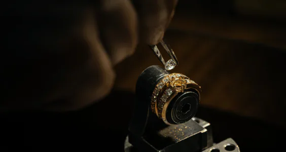 Jeweler inspecting a ring setting under magnification before choosing a care method