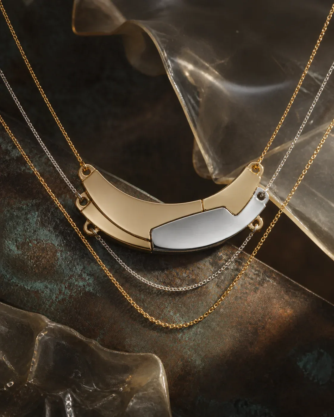 AI-assisted Switchroom design study of a curved contrasting metal-tone layer keeper joining three necklace chains, not a photographed product