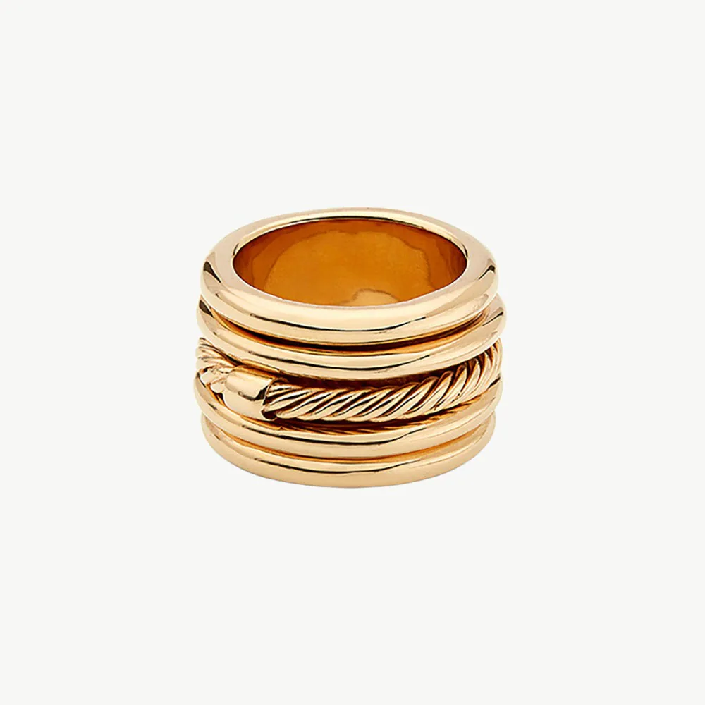 Gold spinner ring with layered moving bands photographed on a clean background