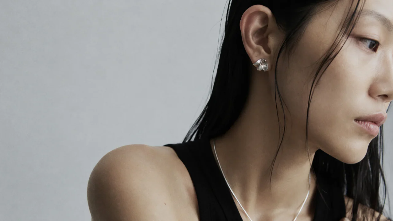 Adult model wearing a fine-scale earring and necklace in close profile