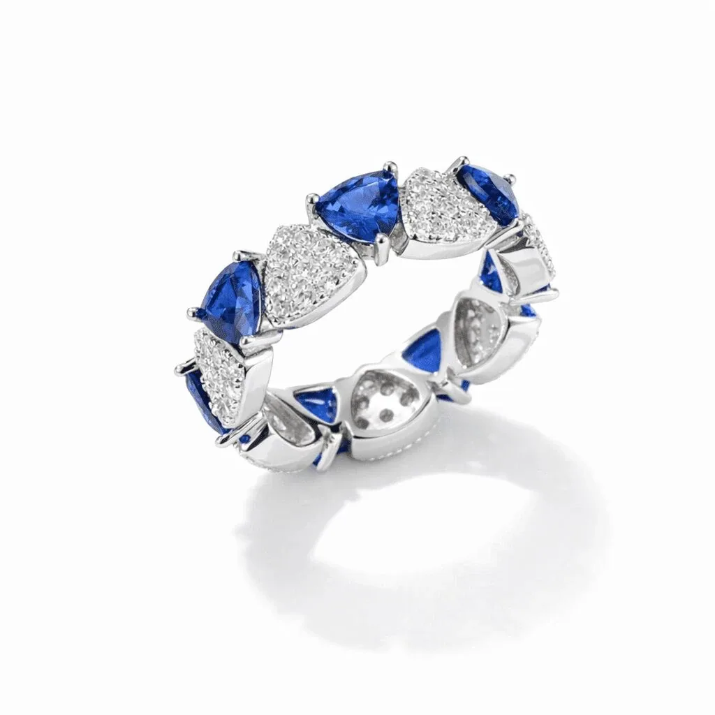 silver-tone eternity ring with alternating blue and clear heart-shaped accents in a repeating band