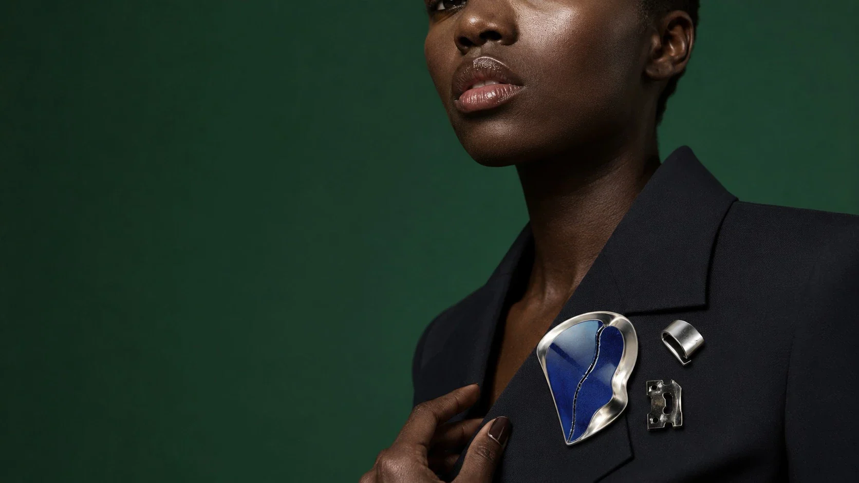 symbol failure merchandise — a cracked enamel pin with a pristine outfit