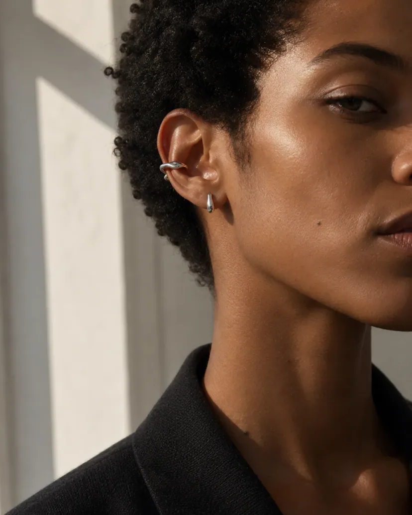 Ear cuff earrings styling with one silver-tone cartilage cuff and one simple silver-tone lobe earring.