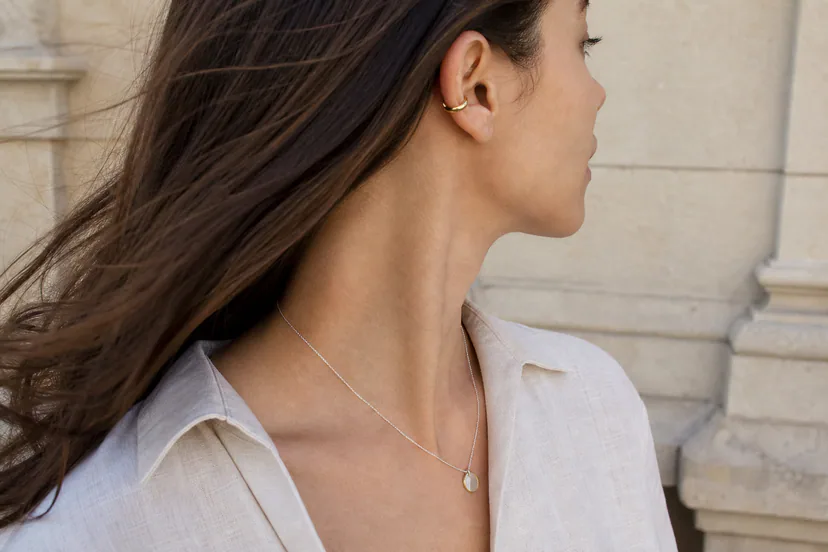 Adult model wearing curved silver and gold jewelry with realistic scale and movement