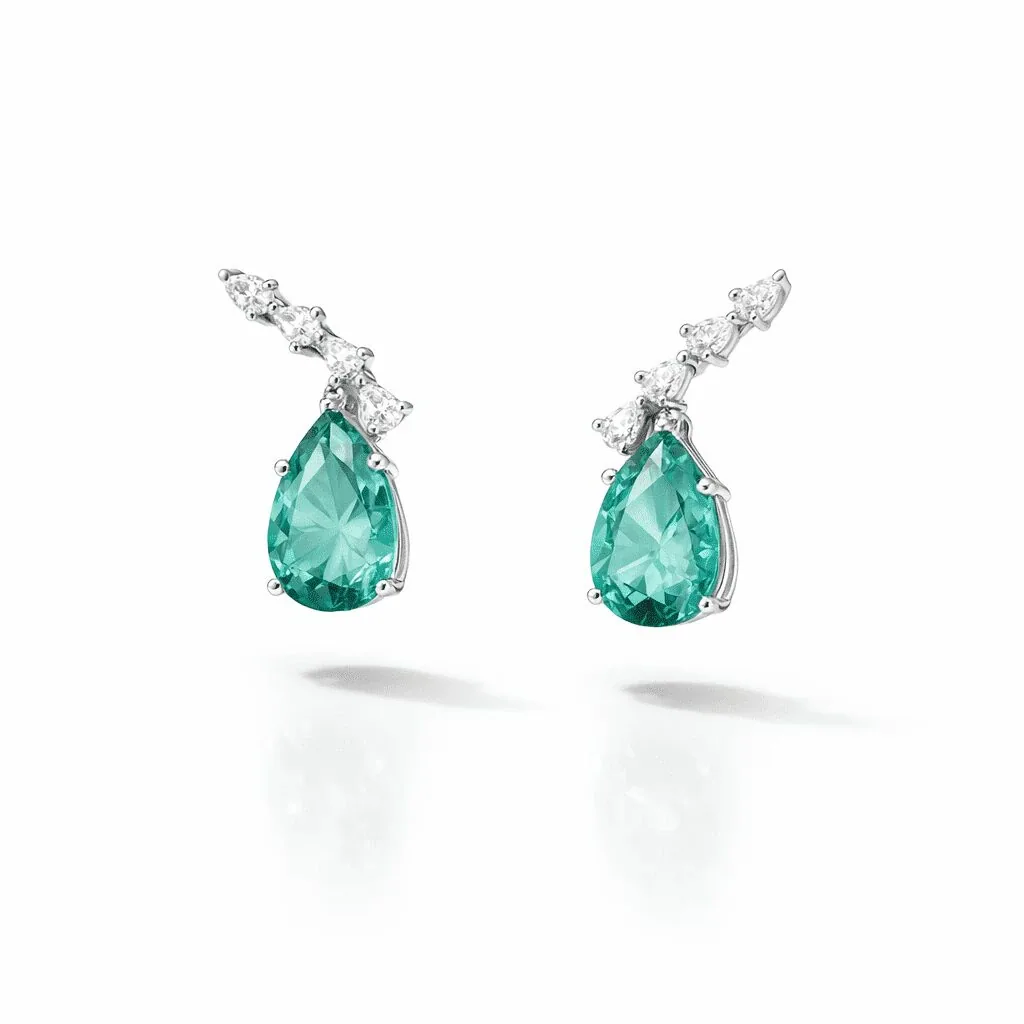 silver-tone drop earrings with emerald-green pear-shaped accents and a row of smaller clear accents