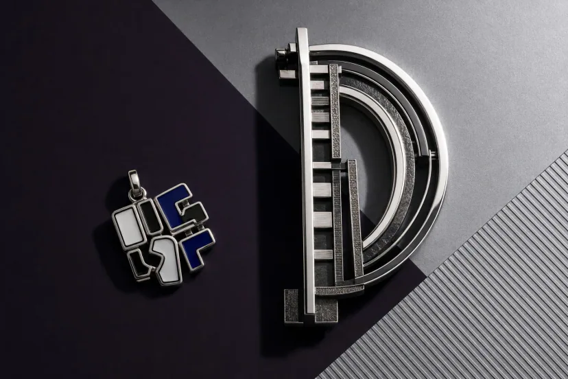 symbol failure merchandise — a meme-worthy misspelling on a charm beside a flawless art object
