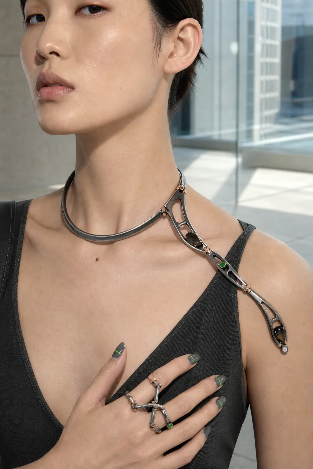 Oxidized and polished sculptural metal jewelry showing surface contrast in daylight