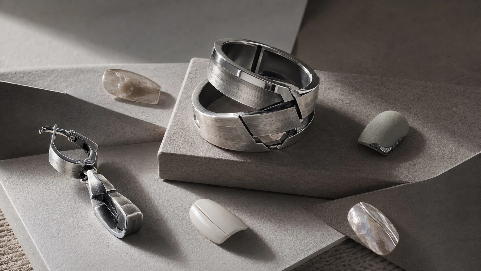 Press-on nails as miniature canvases arranged with sculptural silver rings and vivid color accents as wearable art.